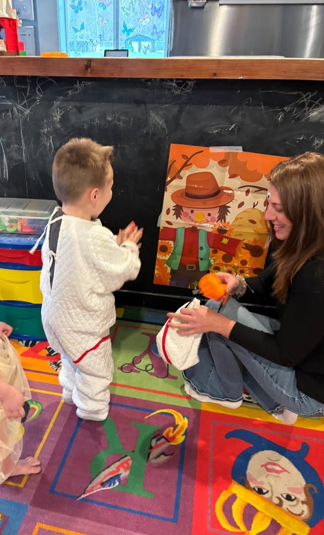 A child and teacher at the chalkboard